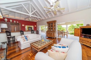 Great room with large HD-TV. Outside lounge on the covered terrace. Ocean view.