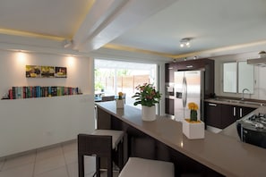 Fully equipped air-conditioned kitchen with electric oven, induction cooker, microwave, fridge and freezer, dishwasher, toaster, coffee maker, blender, electric kettle. Outdoor table on the covered terrace.