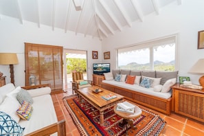 Open-air living room, ceiling fan, HD-TV, french satellite. 