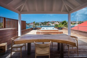 Beautiful dining table for 6 guests in the living room, outdoor dining table on the covered terrace. 