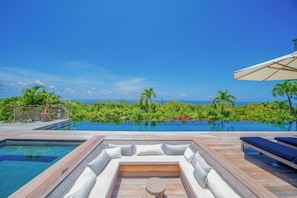Large deck terrace around the heated swimming pool with stairs, jacuzzi, several sun beds with parasol, gas barbecue, outdoor sound system.