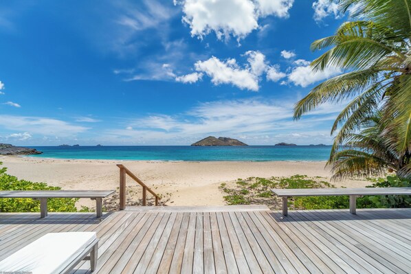 Hammock and wood lounge chairs. Outside shower. Direct access to the beach.