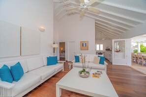 Inside living room with HD-TV, DVD player, Dish Network satellite, iPod dock, ceiling fan.