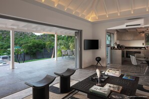 Air-conditioning, large HD-TV with Dish Network, Apple TV, Canal Satellite, iPod dock. The living room opens onto the terrace.
