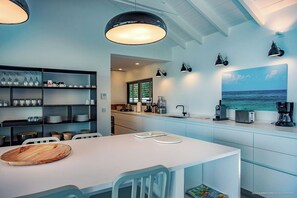 Fully equipped kitchen. Electric oven, gas stove, microwave, refrigerator, mixer, centrifuge, freezer, dishwasher, Nespresso machine, blender, kettle, toaster, breakfast bar. Dining table for 8 people on the covered terrace.