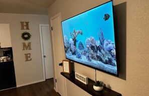 65 inch TV in the living room for the whole family to watch their favorite movie or show