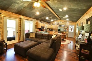 Comfy living room with plenty of space to relax and access to the back deck.