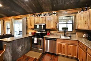 Fully socked kitchen with stove/oven, dishwasher, refrigerator, microwave.