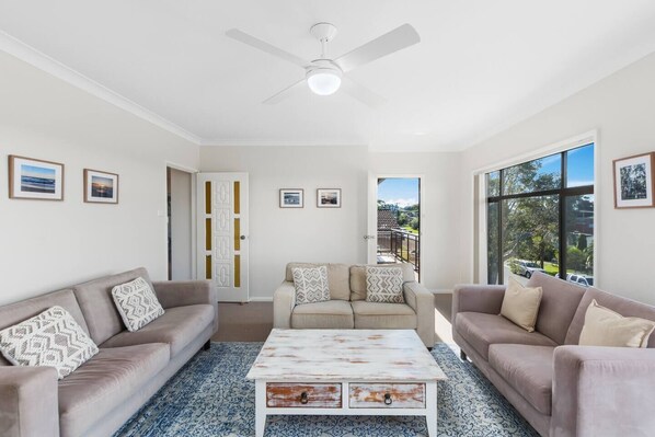 The cosy living area is replete with plenty of seating for the entire group, loads of natural light and a ceiling fan to keep you cool in the warmer months. 
