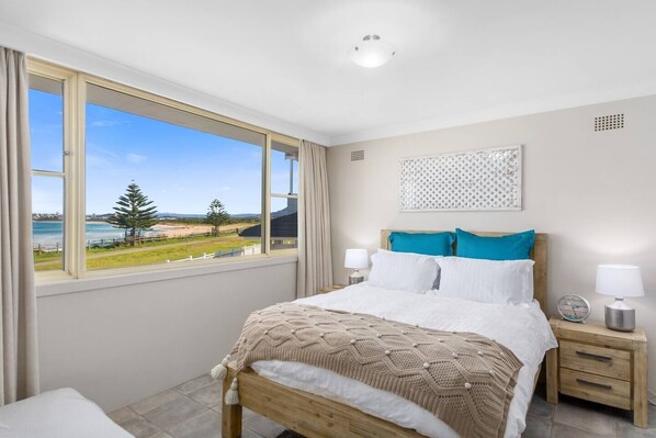  The light and airy first bedroom offers a queen-size bed as well as stunning ocean views.
