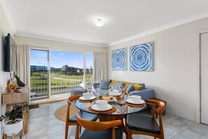 Enjoy meals together in the open dining area, which offers a four-seater table setting and open views overlooking the neighbouring park. 
