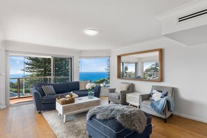 The open plan living room captures breathtaking views across the ocean, with a large balcony capturing the breeze.
