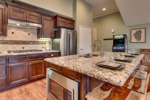 Kitchen area with large island and granite counter tops