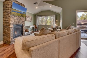 Living area with comfy couch, flat-screen TV, and gas fireplace