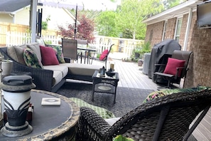 Ample seating on large covered deck! Outdoor table with umbrella for enjoyable meals outside!