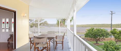 The open plan living area extends to an alfresco dining area with views across to Fraser Island.