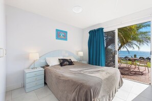 The spacious master bedroom offers a queen-size bed and an ensuite, as well as water views and direct access to the front patio. 
