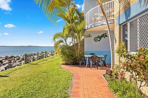 Guests can dine alfresco on the front patio while overlooking the water.  
