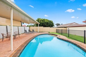 After a leisurely day in the sun, cool down with a dip in the large, in-ground pool.
