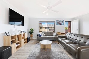 The welcoming lounge area includes two large sofas and a TV where guest can settle in with a movie.
