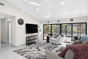 Living room overlooking screened patio, smart TV