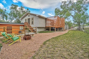 Enjoy a peaceful retreat in the spacious backyard, complete with seating and a fire pit for cozy evenings