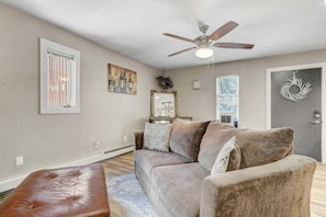 Unwind in the cozy living room, featuring plush seating and a peaceful ambiance.