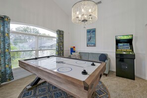 Game room with air hockey table, Golden Tee golf arcade game, TV, futon and more!