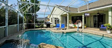Amazing outdoor living with a heated saltwater pool and spa, plenty of seating an an outdoor TV