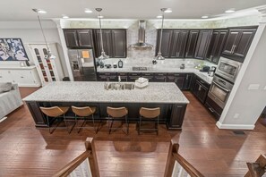 Large, well-stocked kitchen with stainless steel appliances