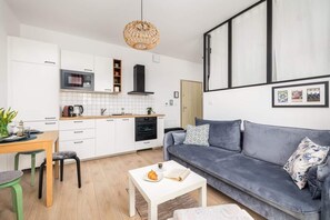 An open-plan living area connecting the kitchen, dining, and lounge spaces with stylish décor.

