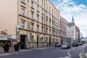 A street view of a European city, showcasing historic architecture and a quiet road.

