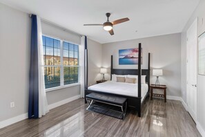 Panoramic main bedroom of the condo in Orlando - Featuring a lavish king-size bed - Serene sanctuary where relaxation reigns supreme. - Decored with Island view wall painting