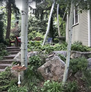 Courtyard garden stairs leading to furnished outdoor sitting area