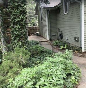 Garden walkway to furnished outdoor sitting area