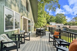 Large upper level deck with outdoor dining and lounge furniture