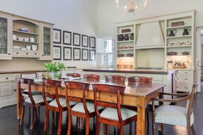 Spacious kitchen with 10 seater dining room table and chairs in the open plan. 