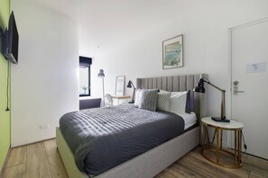 Sink into the plush queen bed in the primary bedroom and enjoy the well-lit workspace by the large window—ideal for both productivity and relaxation.