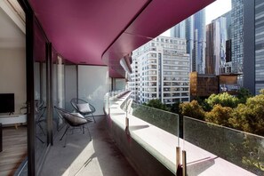 A private balcony spans the entire length of the apartment and offers views of the city, State Library and park below.