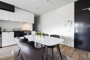 Staying in? Cook up a storm and relax in dining area featuring a chic, marble table that can seat four guests