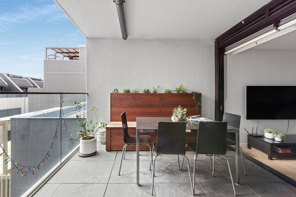 Open up the doors and enjoy spacious private balcony with dining seating. Garden plants and fairy lights help bring a trendy vibe to this home.