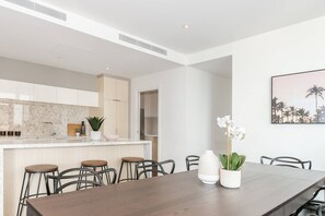 Make use of bright, open-plan living with a large kitchen island and dining table that seats eight people.