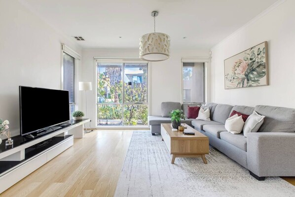 Ample sofa seating is perfect for large families or groups. Enjoy movie nights at home with a flat-screen TV replete with Netflix.