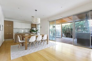A beautifully designed kitchen and dining area extends to an alfresco dining deck perfect for enjoying a meal either indoors or out.