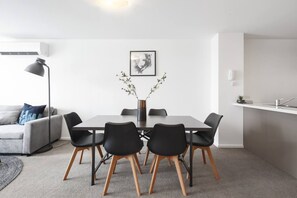 In the living and dining space, there is a large table set for six making it easy for guests to come together for a shared meal at home. 