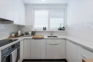 The kitchen is equipped for all your cooking needs, and fitted with a fridge, stove, oven, microwave, kettle and toaster.