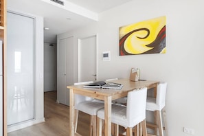 A four-person dining table in the living area allows guests the space to come together for a shared meal. There are also abundant restaurants and eateries nearby.