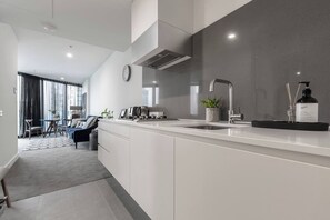 The sleek and tasteful kitchen offers everything you might need for a delicious meal.