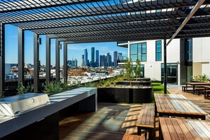 Make use of the spacious, communal barbecue with plenty of seating and even more incredible views of the CBD