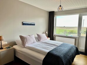 Bedroom 3 - King and single bed. Entrance to patio with hot tub. 
